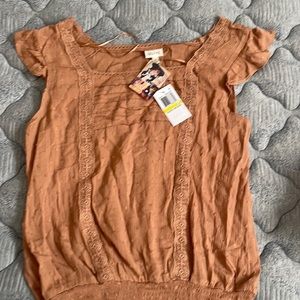 Medium top but fits and looks like a small .